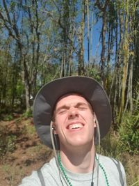 Portrait of smiling young man in forest