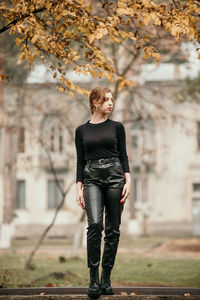 Full length of young woman standing in park