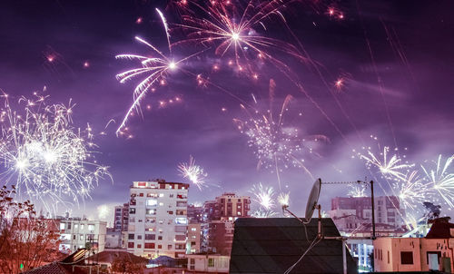 Low angle view of firework display against sky at night