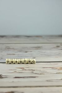 Close-up of text on wood against sky