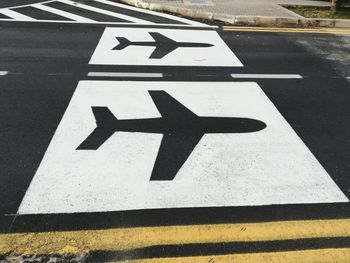 High angle view of arrow sign on road