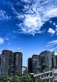 Low angle view of buildings against blue sky