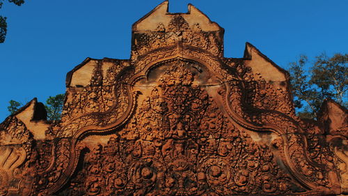 Low angle view of ornate building against clear blue sky