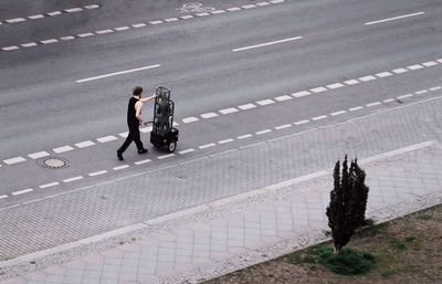 High angle view of people walking on road