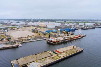 High angle view of harbor by river against sky