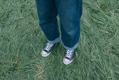 Low section of person standing on field