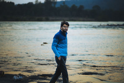 Young man standing on beach