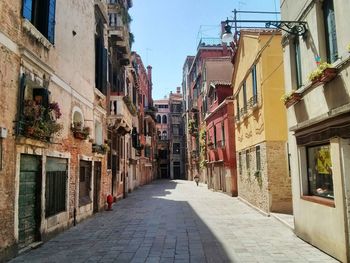 Narrow street amidst buildings in city