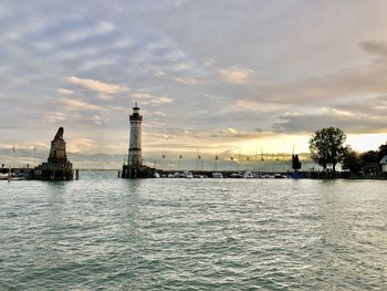 Scenic view of river and buildings against sky during sunset