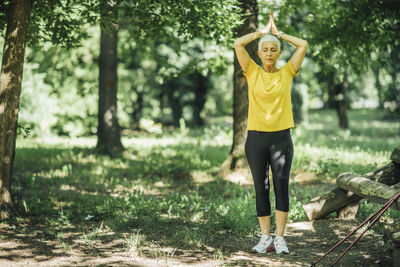 Full length of mature woman exercising at park