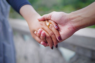 Cropped image of couple holding hands 