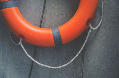 Close-up of life belt hanging on concrete wall