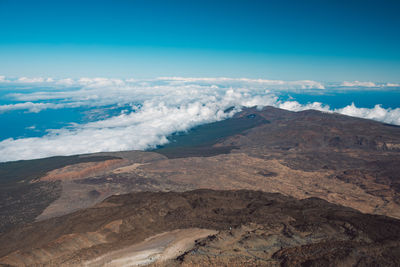 Scenic view of dramatic landscape against blue sky