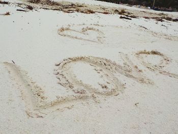 High angle view of heart shape on sand