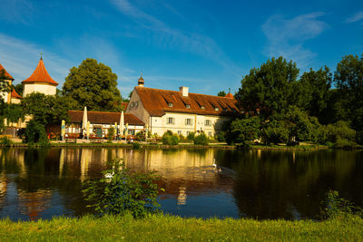 Reflection of trees and buildings in lake