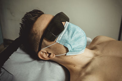 Man lying down on bed at home