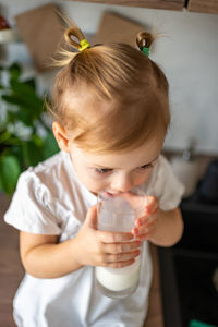 Close-up of girl blowing bubbles at home