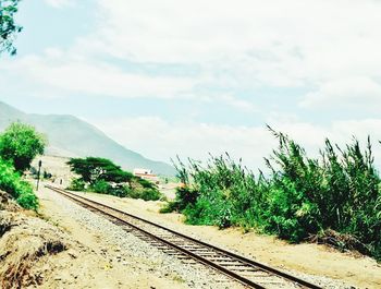 View of railroad track against cloudy sky