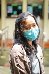 Portrait of beautiful woman standing on street