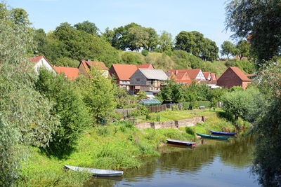 Moored boats against built structures and plants