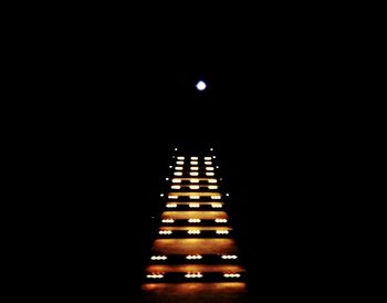 Low angle view of illuminated building against clear sky at night