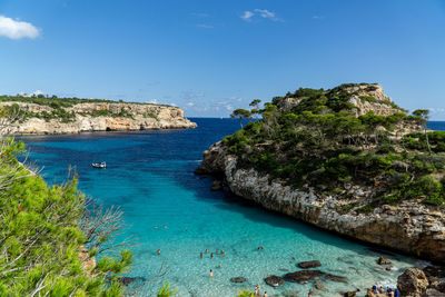 Scenic view of bay against blue sky