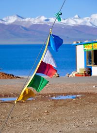 Colorful prayer flags against lake