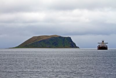 Scenic view of sea against cloudy sky