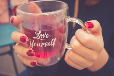 Close-up of woman holding coffee cup