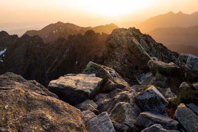 Rocks on mountain against sky during sunset