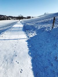 Snow covered field against sky