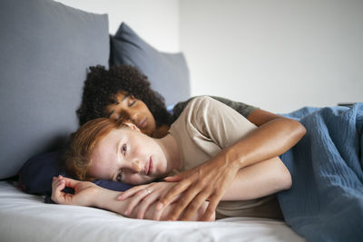 Young couple lying on bed