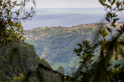 Scenic view of sea and mountains against sky