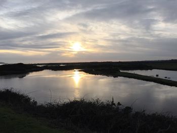 Scenic view of lake against sky during sunset