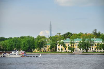 Boats in river with buildings in background