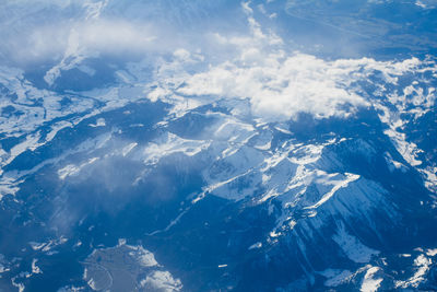 Aerial view of snowcapped mountains against sky