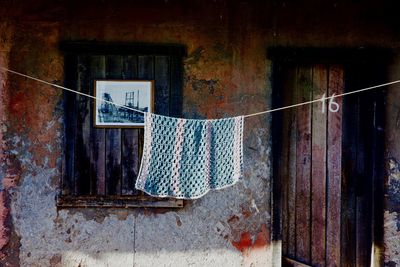 Clothes hanging on wall of old building