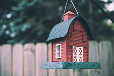 Close-up of birdhouse hanging in yard