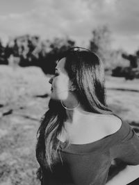 Close-up of beautiful young woman looking away