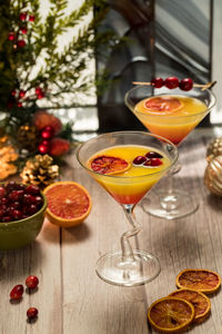 Two refreshing cranberry orange mimosas against a festive background.