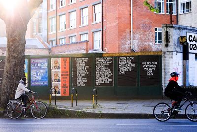 Bicycles on street against building in city