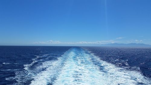 Scenic view of sea against clear blue sky