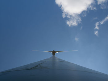 Low angle view of traditional windmill against blue sky