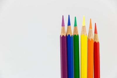 Close-up of colored pencils against white background