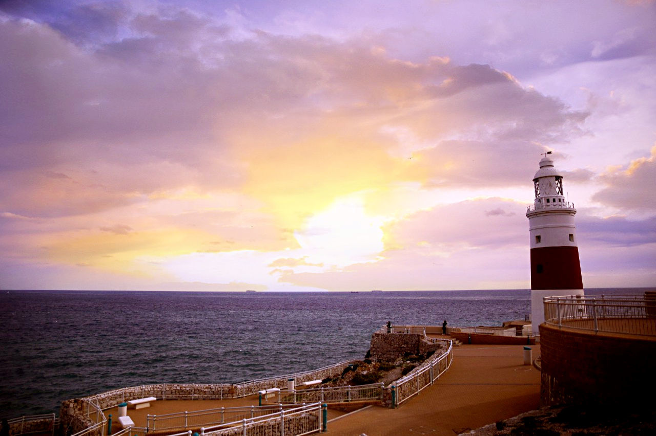 sea, horizon over water, water, sky, beach, lighthouse, built structure, scenics, cloud - sky, architecture, beauty in nature, sunset, shore, tranquil scene, nature, tranquility, guidance, idyllic, protection, building exterior