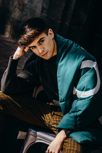 Portrait of young man sitting outdoors