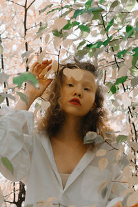 Portrait of happy woman with plants