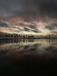 Scenic view of sea against dramatic sky during sunset