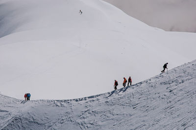 People skiing on snowcapped mountain