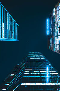 Low angle view of illuminated skyscraper at night